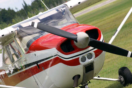A small engine plane is parked on the airfield.