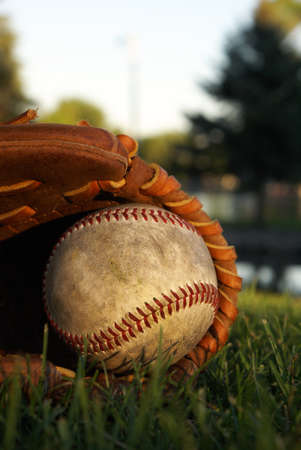 An old baseball mitt In the grass.の写真素材