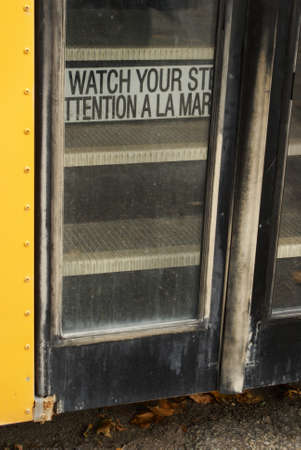 Closeup view of a buses doors entrance and steps.