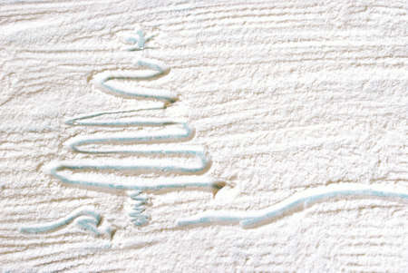 Creative Christmas tree drawn during baking time in the flour.の写真素材