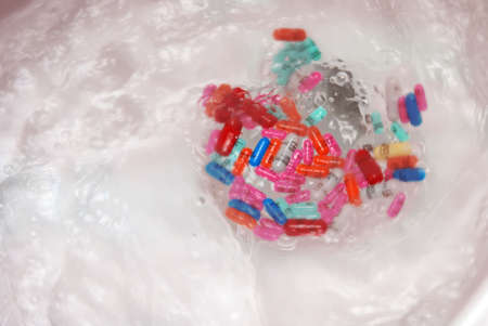 Ottawa, Ontario - July 18, 2015:  Various Hydromorphine Contin MG doses being flushed down a toilet.  Hydromorphine's a strong analgesic drug from the Opioid class used for the relief of chronic pain.のeditorial素材