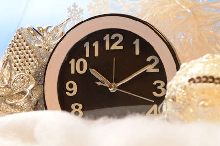 A clock and various decoartions represent the time for Christmas during the winter motnh of...