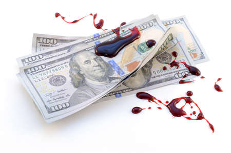 Corruption concept with the use of American hundred dollar bills soaked in dripping fresh red blood.の写真素材