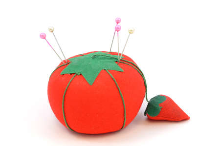 An isolated image of a tomatoe shaped pin cushion for holding pins while doing needle work.の写真素材