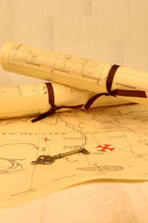 An old fashioned map and key outlining a path to reveal buried treasure at the x marking the spot.の写真素材