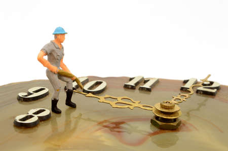 A scale model man pushes time forward.