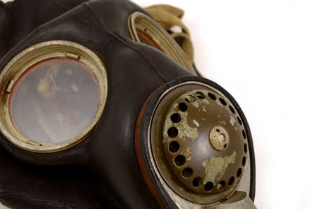 A closeup view of an antique Military grade gas mask over a white background with wear and tear distinguishing its age and vintage.の写真素材