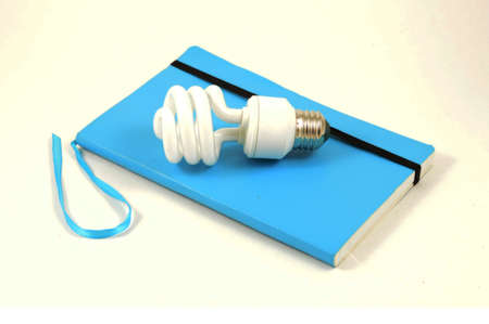 An isolated notebook and lightbulb to simulate ideas.の写真素材