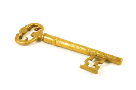 An isolated over white image of a large brass key.の写真素材