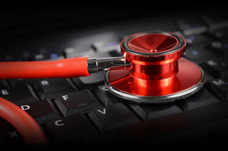 A red stethoscope and keypad represent the new age digital Doctors appointments more commonly seen today.の写真素材