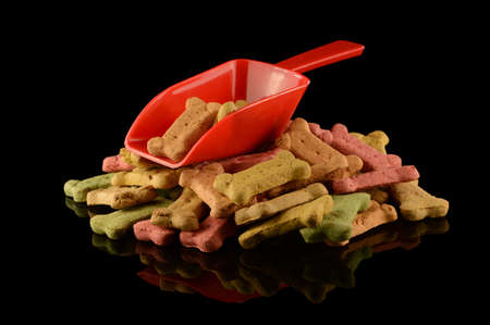 A scoop serving some various dog treats for the canine friend.の写真素材