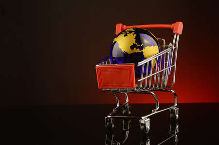 A conceptual image of global shopping over a red background.の写真素材