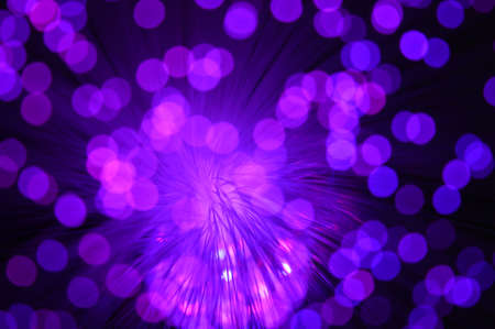 A purple abstract background from a series of color changing images of the same scene of fiber optic cables.の写真素材