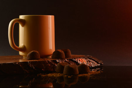 A composition of coffee and fine chocolate truffles for a tasteful display.の写真素材