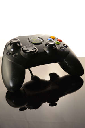 SMITHS FALLS, ONTARIO, CANADA: JANUARY 23, 2021 - An Xbox video game controller over a black and white reflective background.のeditorial素材