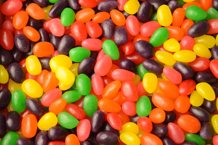 A full horizontal frame of many various jelly bean candy to create a sweet background.の写真素材