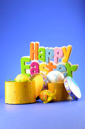 A festive holiday scene with the words saying Happy Easter over a blue background.の写真素材