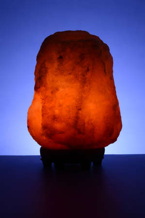 A closeup of a Himalayan Salt Rock over a blue background.の写真素材