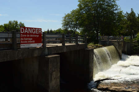 SMITHS FALLS, ONTARIO, CA, JUNE 12, 2021: The reservoir dam located on the Rideau Canal in Smiths Falls, Ontario showing its flowing currents of water.のeditorial素材