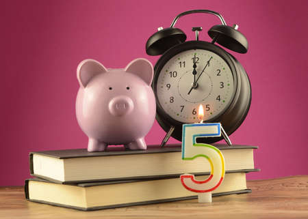 A financial celebration of five years with this piggy bank and numbered candle.の写真素材