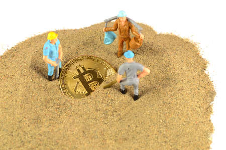 A few good miners mine for some new bitcoin to add to the cryptocurrency volume.の写真素材