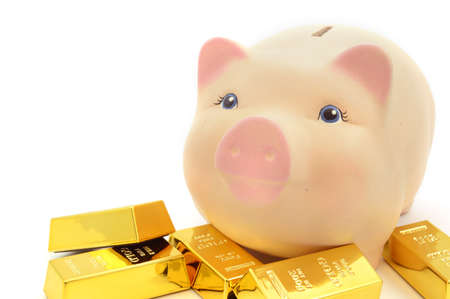 A unique pig bank and gold bullion bars over a white background.の写真素材