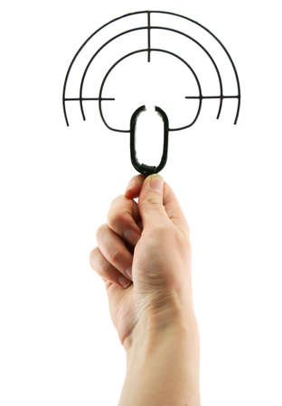 Female hand holds old metallic rifle backsight isolatedの写真素材