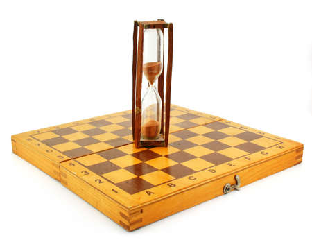 Chessboard and hourglass isolated on a white backgroundの写真素材