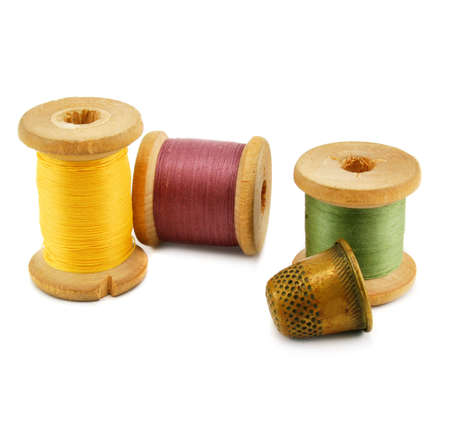 Spools of thread and thimble isolated on a white backgroundの写真素材
