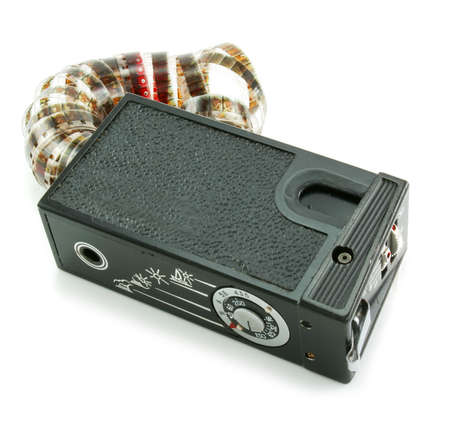 Small espionage photo camera and film isolated on a white backgroundの写真素材