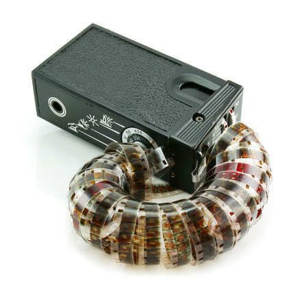 Small espionage photo camera and film isolated on a white backgroundの写真素材