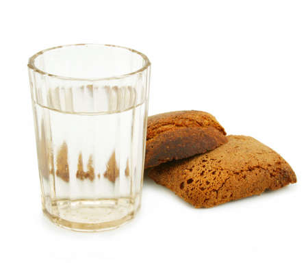 Crust of bread and glass of alcohol isolated on a white background の写真素材