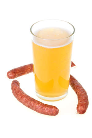 Cup of beer and grilled sausages isolated in white backgroundの写真素材