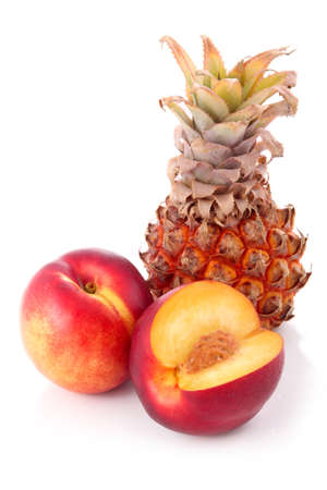 Fresh peach and pineapple fruits with cut isolated on white background の写真素材