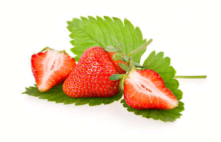 Red sliced strawberry fruits with green leaves isolated on white background の写真素材