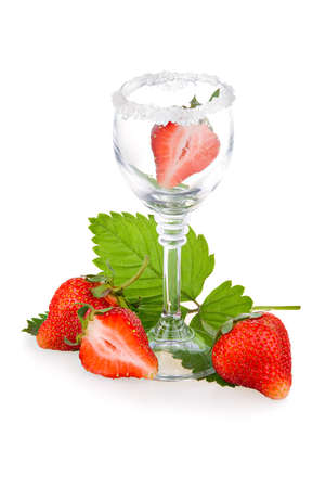 Red strawberry fruits with green leaves in glass isolated on white backgroundの写真素材