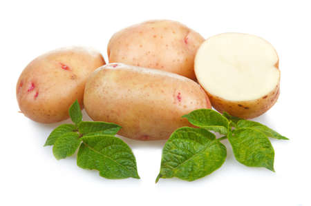 Heap of ripe potatoes vegetable with green leafs isolated on white backgroundの写真素材