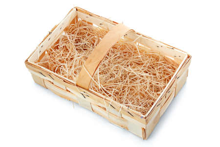 Empty wooden basket with straw isolated on white backgroundの写真素材