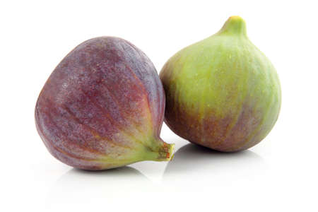 Ripe purple and green fig fruit isolated on white backgroundの写真素材