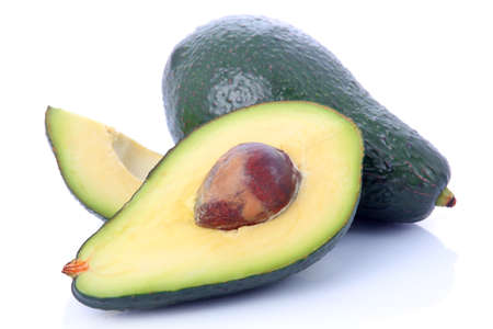 Ripe sliced avocado fruits isolated on white background の写真素材