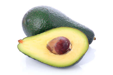Ripe sliced avocado fruits isolated on white backgroundの写真素材