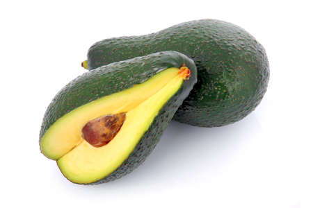 Ripe sliced avocado fruits isolated on white backgroundの写真素材