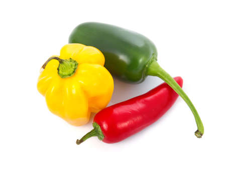 Three colored chili pepper vegetables isolated on white background  の写真素材