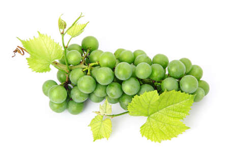 Fresh grape fruits with green leaves isolated on white background の写真素材