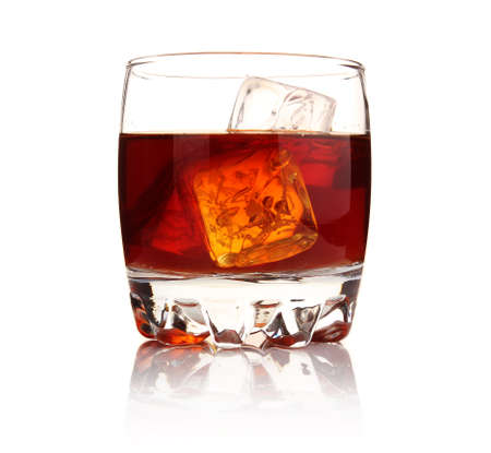 Glass of whiskey with ice cubes isolated on white background の写真素材