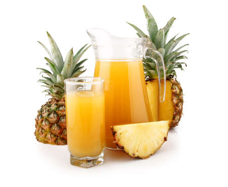 Jug and glass of pineapple juice with fruits isolated on white backgroundの写真素材