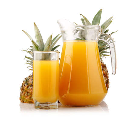 Jug and glass of pineapple juice with fruits isolated on white backgroundの写真素材