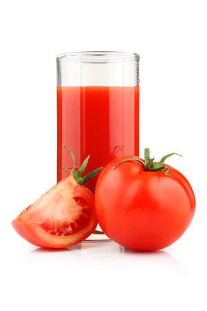 Glass of tomato juice and fruits with green leaves isolated on whiteの写真素材