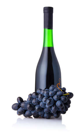 Bottle of red wine with bunch of grapes isolated on white backgroundの写真素材