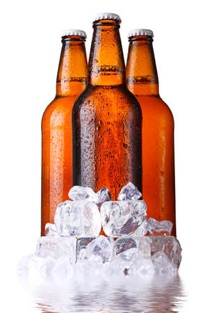 Three brown bottles of beer with ice isolated on white backgroundの写真素材